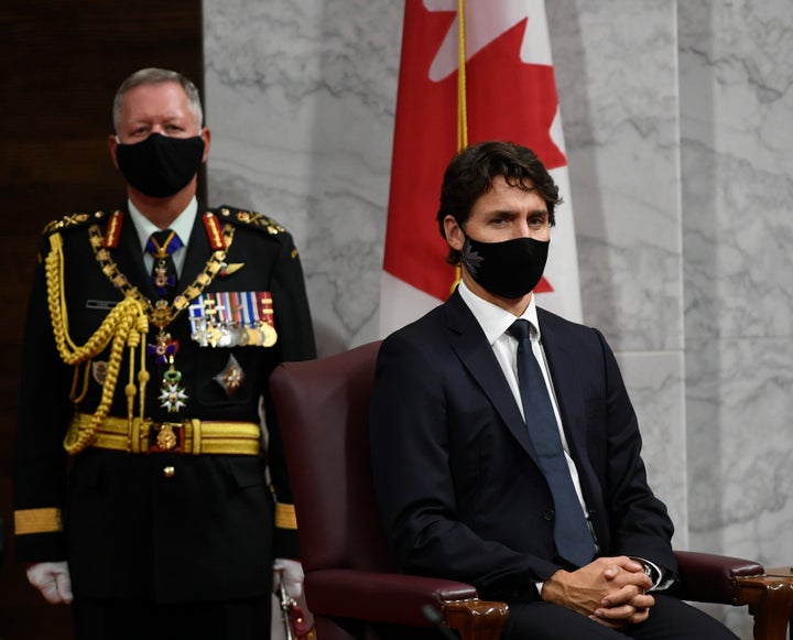 Chief of Defence Staff Jonathan Vance, left, and Prime Minister Justin Trudeau listen to Gov. Gen. Julie Payette deliver the throne speech in the Senate chamber in Ottawa on Wednesday.