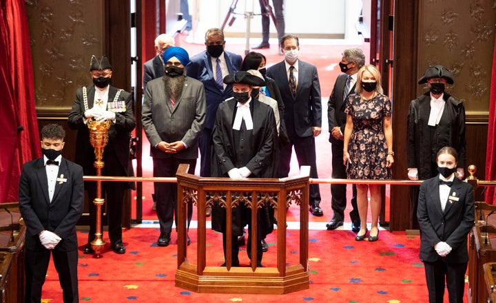 Speaker of the House of Commons Anthony Rota (centre) stands with Members of Parliament to listen to Gov.Gen Julie Payette deliver the Speech from the Throne at the Senate of Canada Building in Ottawa.