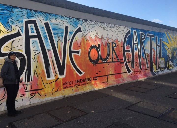 The author in front of the Berlin Wall.