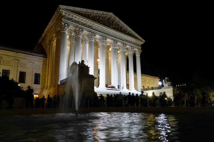 People pay respects as Justice Ruth Bader Ginsburg lies in repose under the Portico at the top of the front steps of the U.S. Supreme Court building on Wednesday.