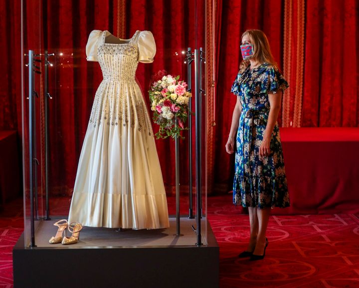 Princess Beatrice poses alongside her wedding dress as it goes on display at Windsor Castle on Sep. 23, 2020 in Windsor, Engl