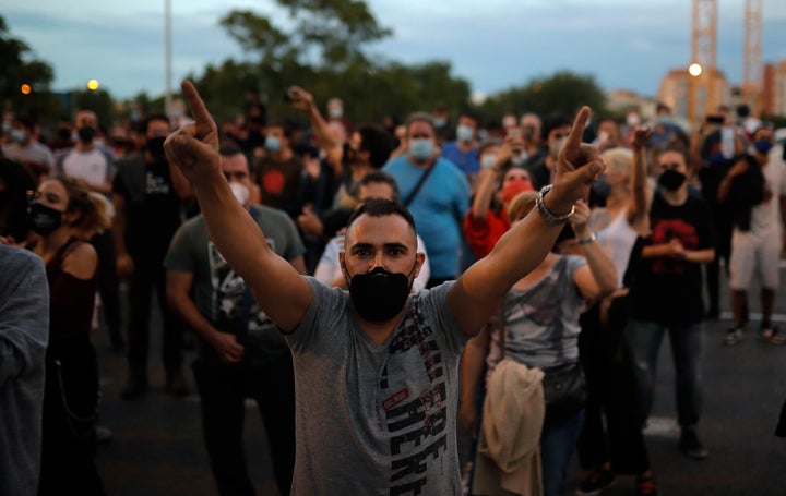 Protesters take part in a demonstration in the Vallecas neighborhood of Madrid against measures imposed by the Madrid regiona