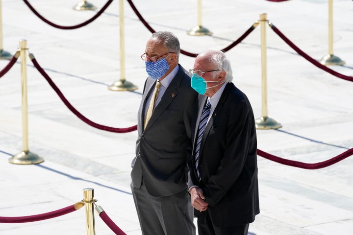 Sens. Chuck Schumer and Bernie Sanders pay their respects as the late Justice Ruth Bader Ginsburg lies in repose at the U.S. Supreme Court on Sept. 23, 2020.