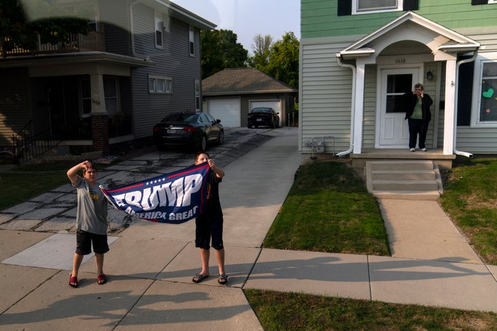 Children hold a pro-Trump banner as Biden's motorcade drives by on Sept. 21.