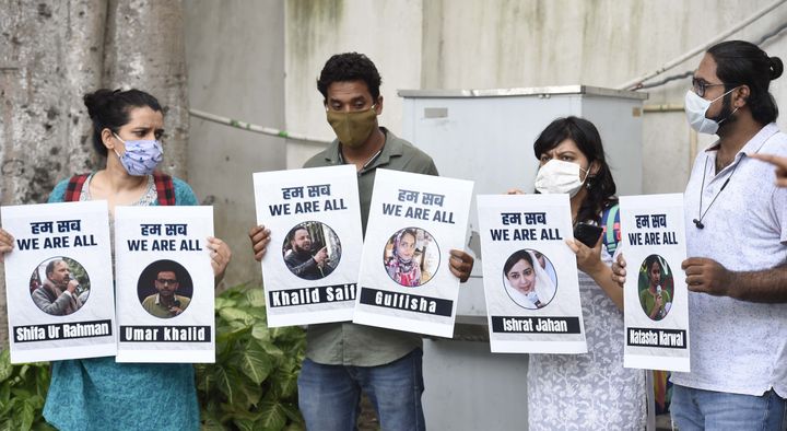 People hold placards during a press conference on the arrest of student activist Umar Khalid, on September 16, 2020 in New Delhi, India. 