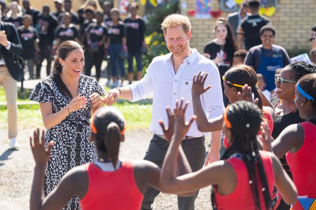 The Duke and Duchess of Sussex meeting a group of dancers at the Nyanga Township in Cape Town, South Africa, on the first day of their tour of Africa, which cost nearly £246,000 