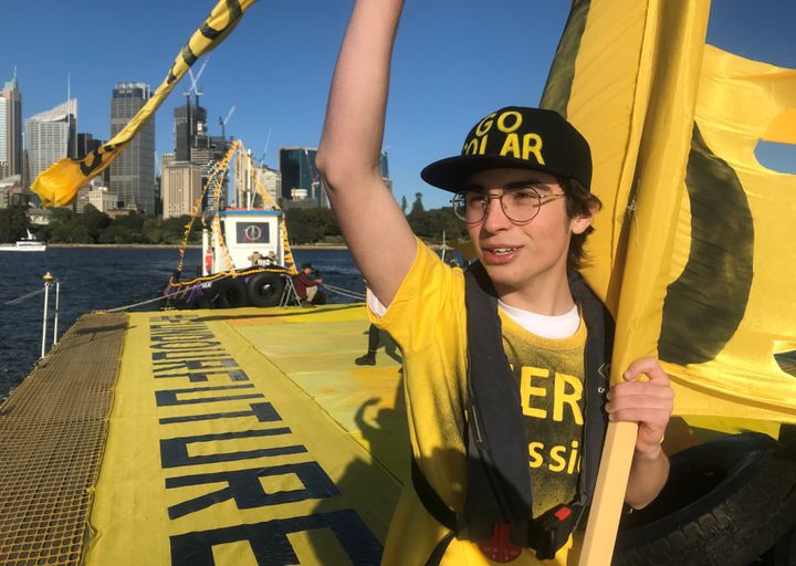 Ambrose Hayes, a 15-year-old climate change activist, rides on a barge during an event as part of the Fund Our Future Not Gas climate rally in Sydney Harbour, Sydney, Australia, September 25, 2020. 