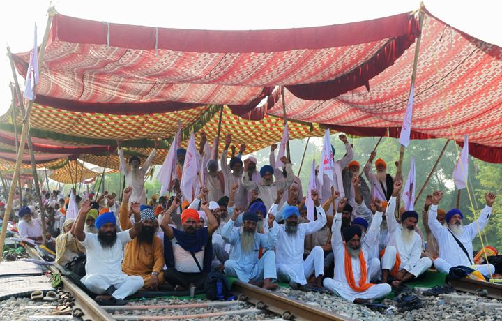 Farmers block train tracks during a nationwide farmers' strike following the passing of agriculture bills in the Parliament, at Devi Dasspura village some 25 kms from Amritsar.