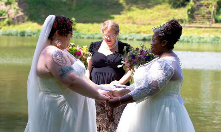 The author (left) and her wife, Jodyann Morgan, being married by L.S. Quinn.