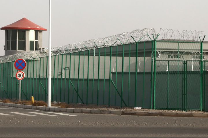 In this Dec. 3, 2018, file photo, a guard tower and barbed wire fences surround an internment facility in the Kunshan Industrial Park which has previously been revealed by leaked documents to be a forced indoctrination camp in Artux in western China's Xinjiang region. 