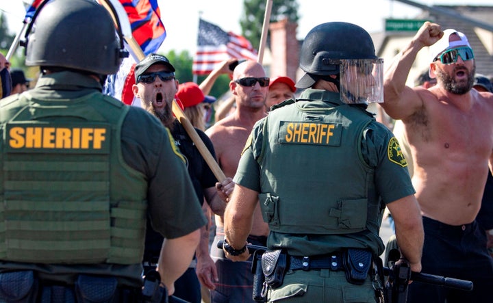 Orange County Sheriff deputies keep protesters and counter protesters apart during demonstrations in Yorba Linda, Calif., on Saturday.