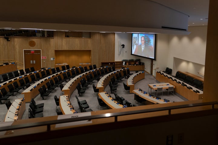 Lebanese President Michel Naim Aoun is seen on a video screen in an empty conference room remotely addressing the 75th sessio