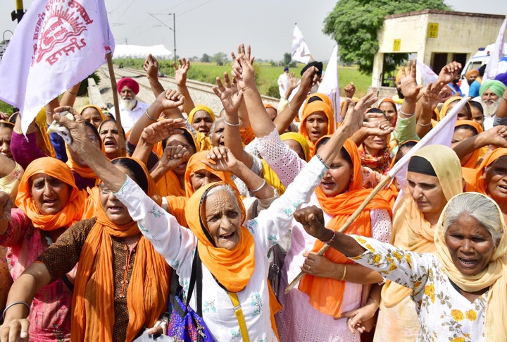 Women raise slogans as they join protesting farmers during the 'Rail Roko' protest against the farm bills, at Devi Dasspura village, on September 27, 2020 in Amritsar. (Photo by Sameer Sehgal/Hindustan Times via Getty Images)