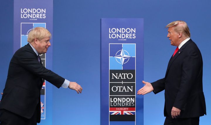 Prime Minister Boris Johnson, left, reaches out to shake hands with U.S. President Donald Trump 