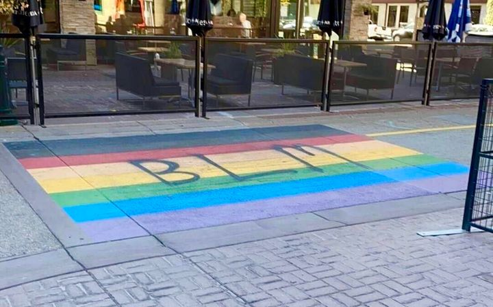 The rainbow crosswalk in Calgary, with BLM spray-painted across it. 