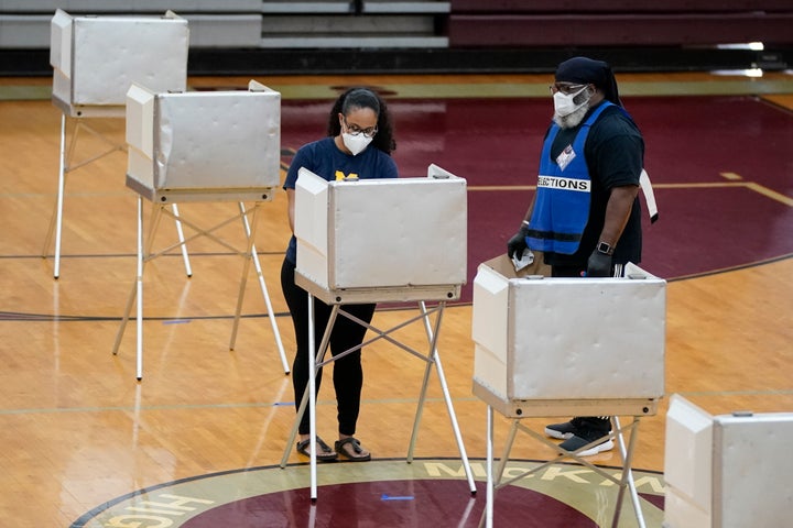A woman wears a face mask as she votes in the primary on June 2, 2020, in Washington, D.C.
