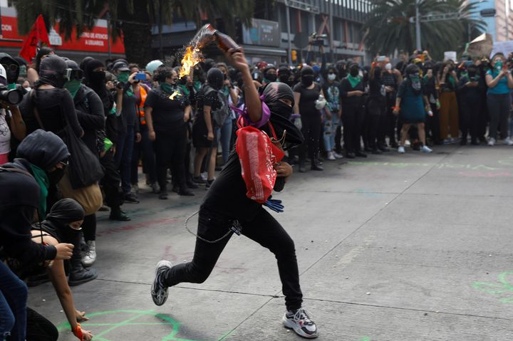 Member of a feminist collective throws a molotov cocktail during a march to mark the International Safe Abortion Day in Mexico City, Mexico September 28, 2020. REUTERS/Carlos Jasso TPX IMAGES OF THE DAY