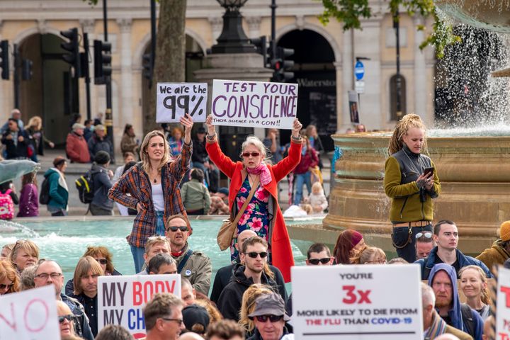 Protesters holding placards expressing their opinion during the We Do Not Consent protests in Trafalgar Square London against Lockdown last year.