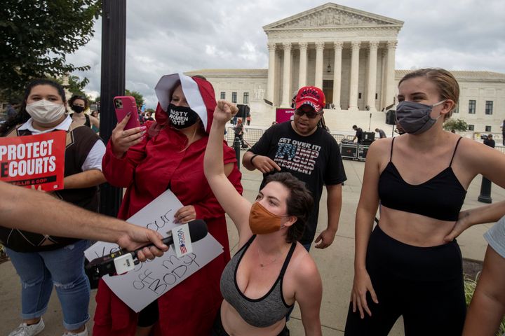 Protestors demonstrate outside the U.S. Supreme Court the day after Trump announced Barrett as his nominee. Though People of Praise opposes abortion, those familiar with the group said it would be a mistake to pigeonhole their politics as either left or right. REUTERS/Tasos Katopodis