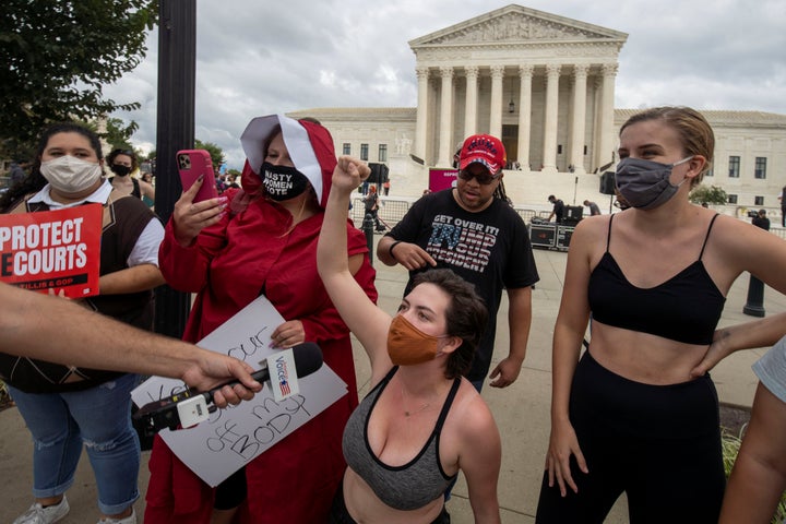 Protestors demonstrate outside the U.S. Supreme Court the day after Trump announced Barrett as his nominee. Though People of Praise opposes abortion, those familiar with the group said it would be a mistake to pigeonhole their politics as either left or right. REUTERS/Tasos Katopodis