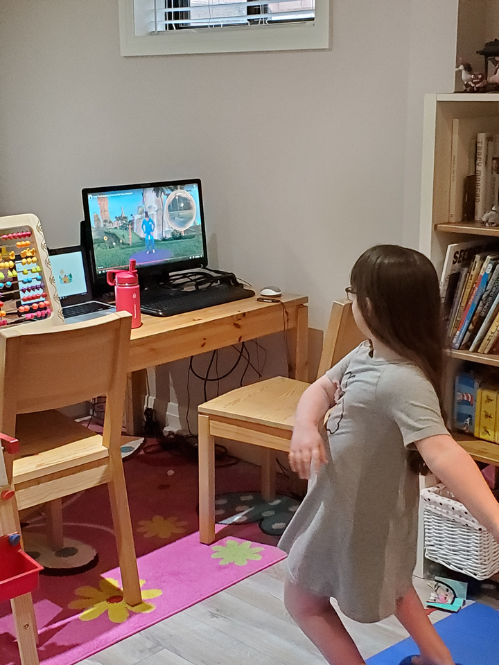 Audrey, seen following along with a yoga tutorial sent by her teacher.