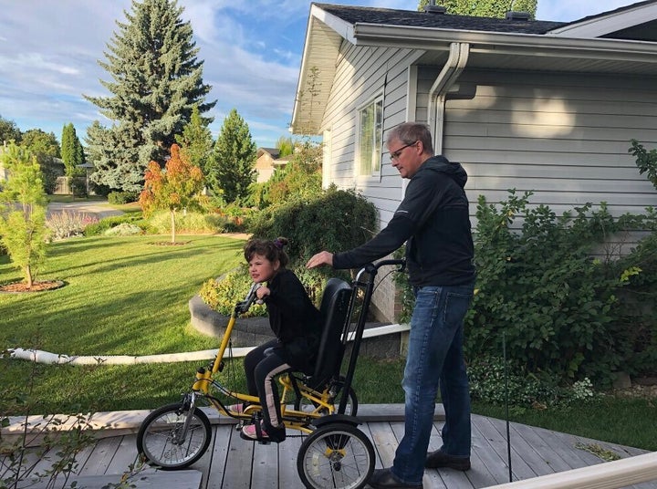 Duane Froese and Annika head to school, on her adapted bike.