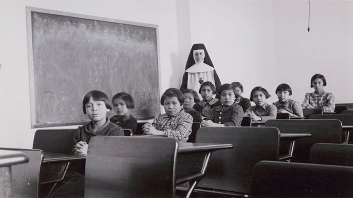 A group of female students and a nun pose in a classroom at Cross Lake Indian Residential School in Cross Lake, Man. in a February 1940 archive photo. It is estimated that more than 150,000 students attended residential schools under a policy the Truth and Reconciliation Commission amounted to "cultural genocide."