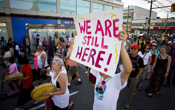 Members of various First Nations walk to honour residential school survivors in Vancouver on June 11, 2015.