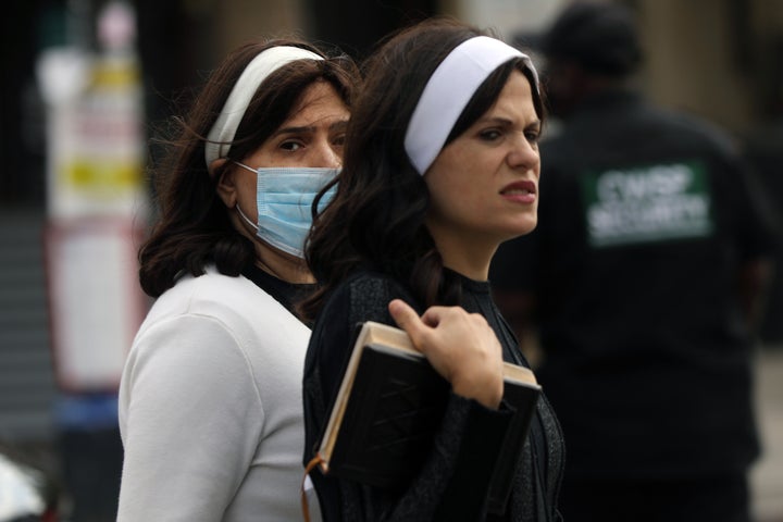 People return from a prayer service in Borough Park where three members of the city’s Orthodox Jewish community died from the coronavirus over the last four days on September 28, 2020 in New York City. 