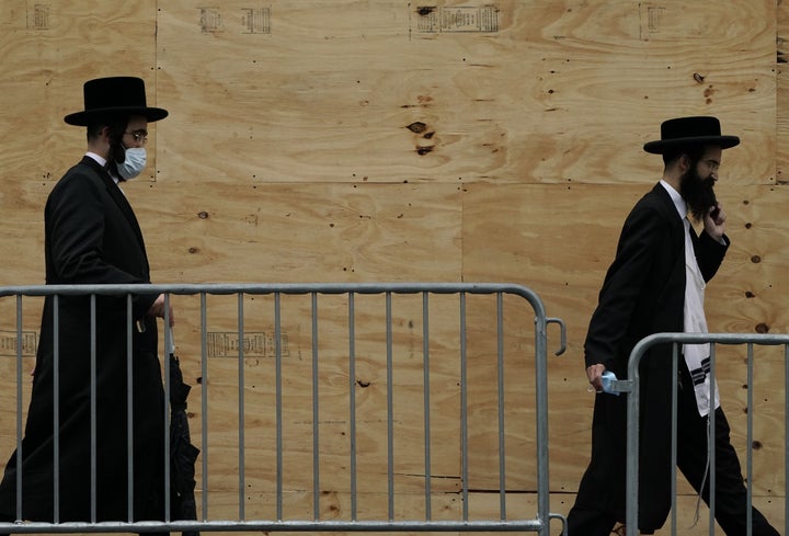 Orthodox Jewish men walk through a Brooklyn neighborhood on September 29, 2020, in New York. 