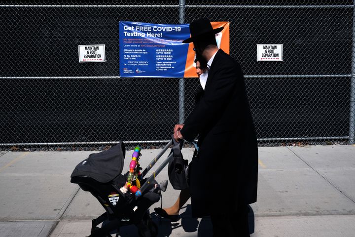 Residents walk by a COVID-19 testing site in the Brooklyn neighborhood of Borough Park on September 23, 2020 in New York City. 