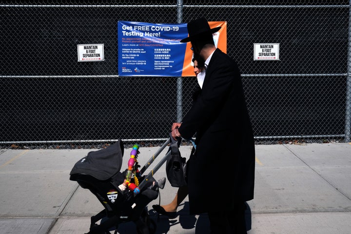 Residents walk by a COVID-19 testing site in the Brooklyn neighborhood of Borough Park on September 23, 2020 in New York City.