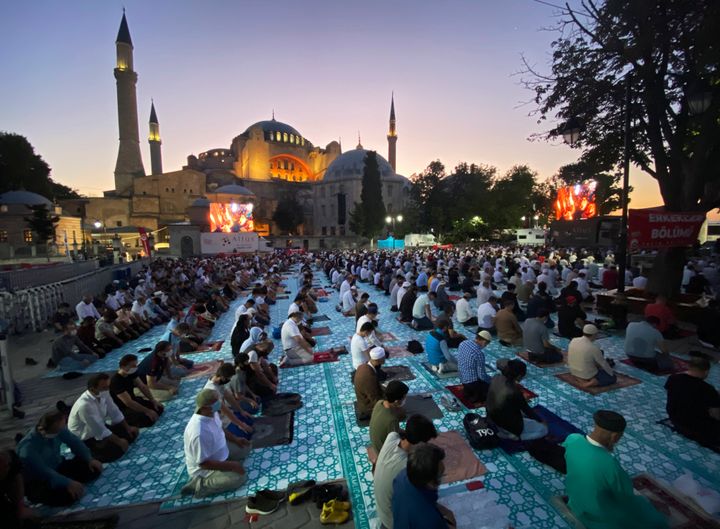 Muslims offer prayers during Eid al-Adha near the Hagia Sophia, recently converted back to a mosque, in Istanbul on July 31, 2020. 