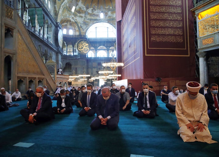 Turkey's President Recep Tayyip Erdogan, center, takes part in Friday prayers inside the Hagia Sophia on Friday, Aug. 7, 2020. 