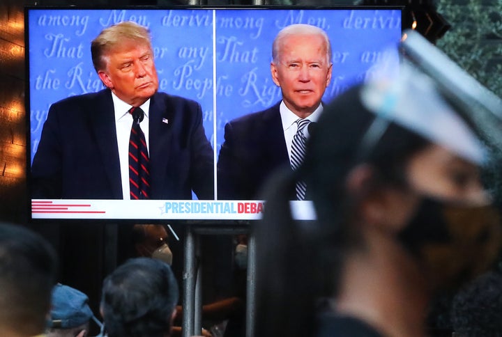 WEST HOLLYWOOD, CALIFORNIA - SEPTEMBER 29: A server wears a face shield and face covering as people sit to watch a broadcast of the first debate between President Donald Trump and Democratic presidential nominee Joe Biden at The Abbey, with socially distanced outdoor seating, on September 29, 2020 in West Hollywood, California. The debate being held in Cleveland, Ohio is the first of three scheduled debates between Trump and Biden. (Photo by Mario Tama/Getty Images)