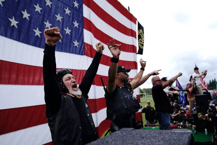 Members of the Proud Boys cheer on stage as they and other right-wing demonstrators rally on Saturday.
