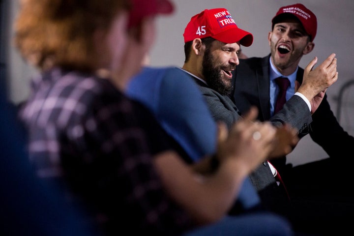 Mike Gee, center, applauds for the president while watching the debate stream in Lititz.