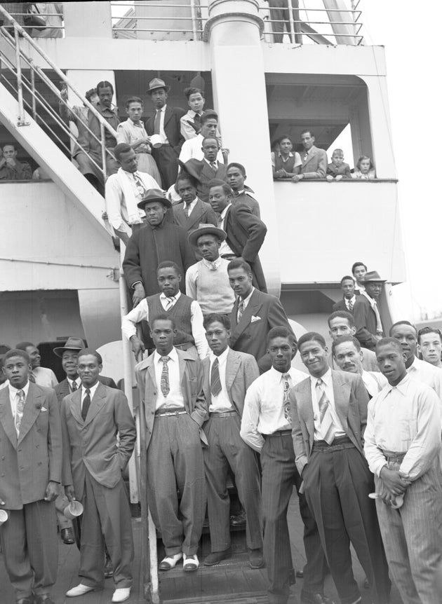 Some of the Jamaican men, mostly ex Royal Air Force servicemen, aboard the former troopship, S.S. Empire Windrush, before disembarking at Tilbury Docks, England, on June 22, 1948. They have come to Britain seeking employment. (AP Photo/Staff/Worth)