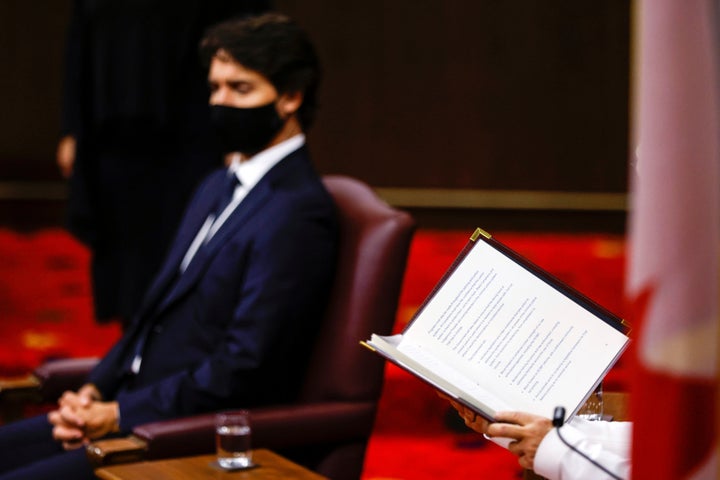 Canada's Governor General Julie Payette (hands and book), with Prime Minister Justin Trudeau, delivers the throne speech in the Senate, as parliament prepares to resume in Ottawa on Sept. 23, 2020. 