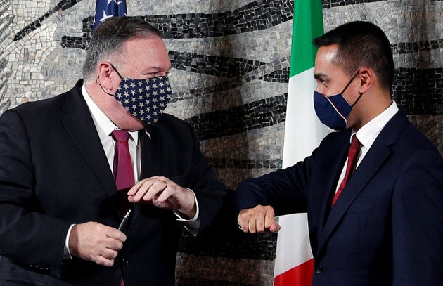 U.S. Secretary of State Mike Pompeo bumps elbows with Italian Foreign Minister Luigi Di Maio at the end...