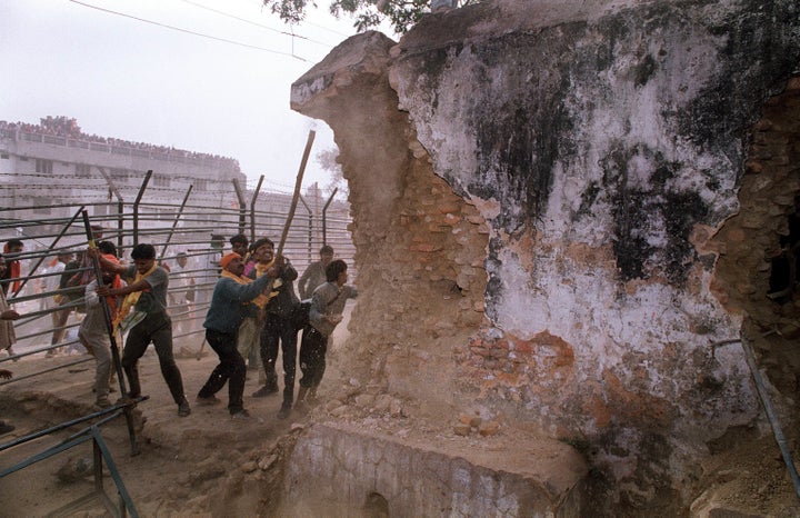 In this December 6, 1992 photograph, Hindu mob attacks the wall of the 16th century Babri Masjid Mosque with iron rods. AFP PHOTO/DOUGLAS E CURRAN/FILES