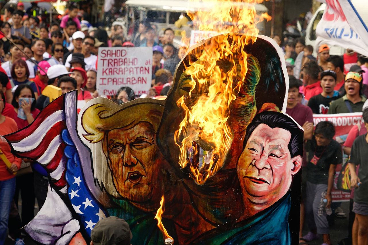 Protesters groups burn an effigy of Duterte, Trump and Chinese president Xi Jinping. 