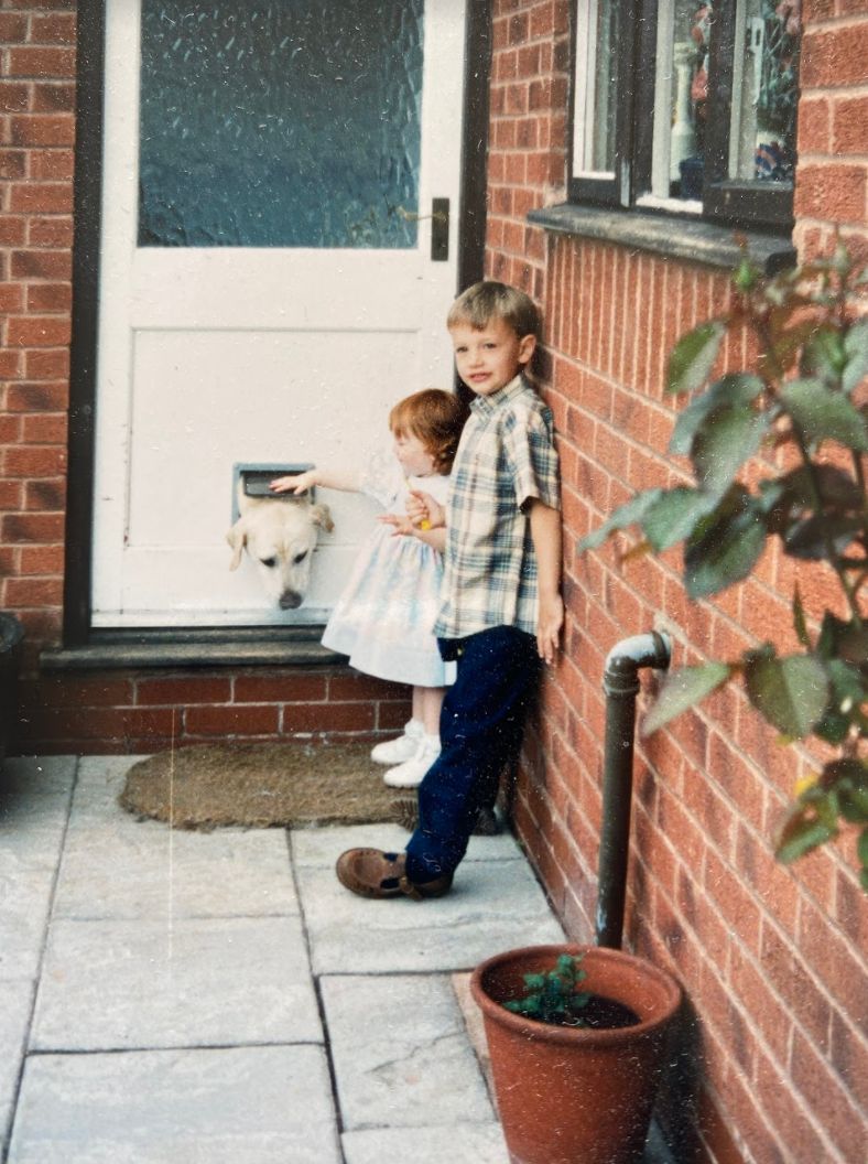 Charlotte and James as young children with their first dog, Major.
