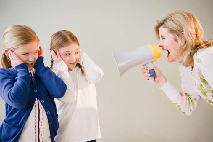 USA, Jersey City, New Jersey, mother shouting at daughters (8-11) through bullhorn