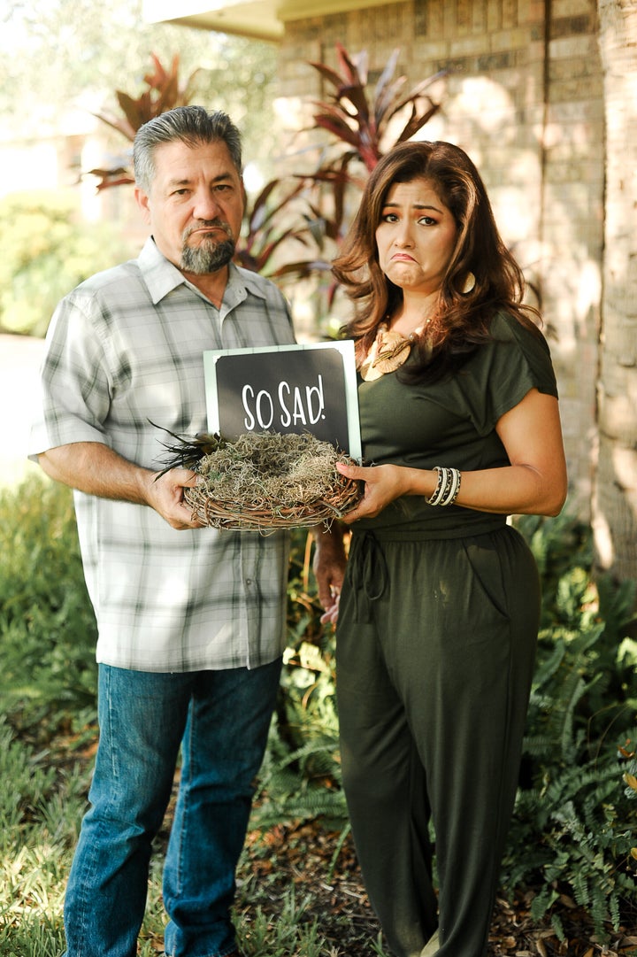 The couple holding up a bird's nest with an accompanying sign.