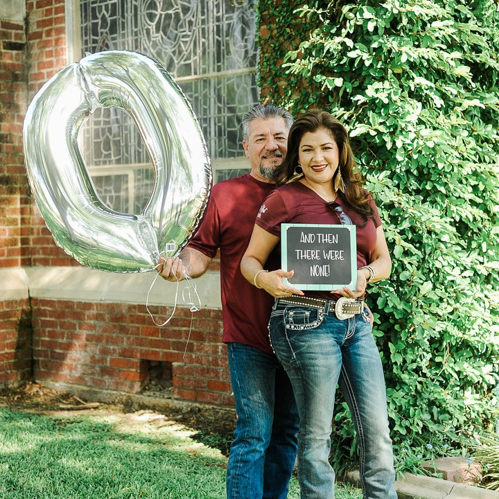 Juan holds up a zero balloon and Dalila holds up a chalkboard sign that reads: "And then there were none."