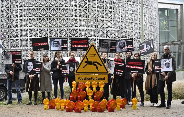 Reporters without Borders members hold placards depicting arrested Saudi writer Raif Badawi (upper left), arrested Saudi journalist Wajdi al-Ghazzawi (upper, second from right), Saudi human rights defender Nassima al-Sadah (upper left), assassinated Saudi journalist Jamal Khashoggi (bottom left) and Saudi women's rights activist Eman al-Nafjan (bottom, second from left) outside the Saudi Arabian Embassy in Berlin a year ago.