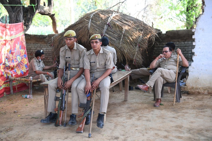 Uttar Pradesh Police personnel keep watch outside the family house of a 19-year-old woman, who was allegedly gang-raped by four men, at Bool Garhi village in Hathras in Uttar Pradesh on September 30, 2020.