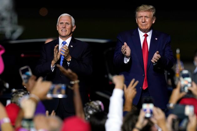 Trump and vice president Mike Pence, who has tested negative, arrive at a campaign rally in Newport News