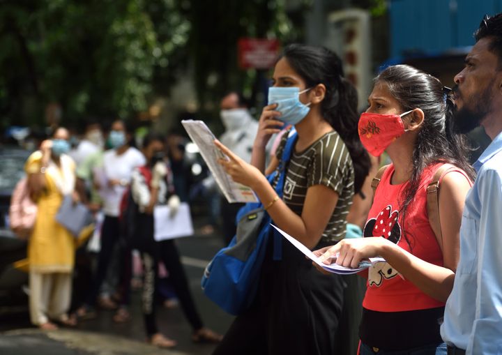 NEET 2020 aspirants stand in a queue outside the exam center at Khar, on September 13, 2020 in Mumbai.